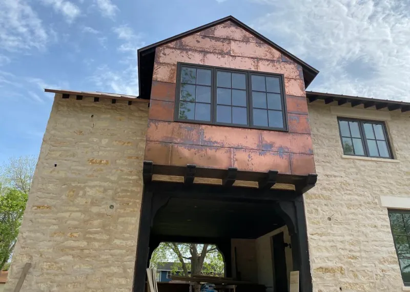 Copper metal panel facade on a stone building for Metal Roof Coating in Grandville