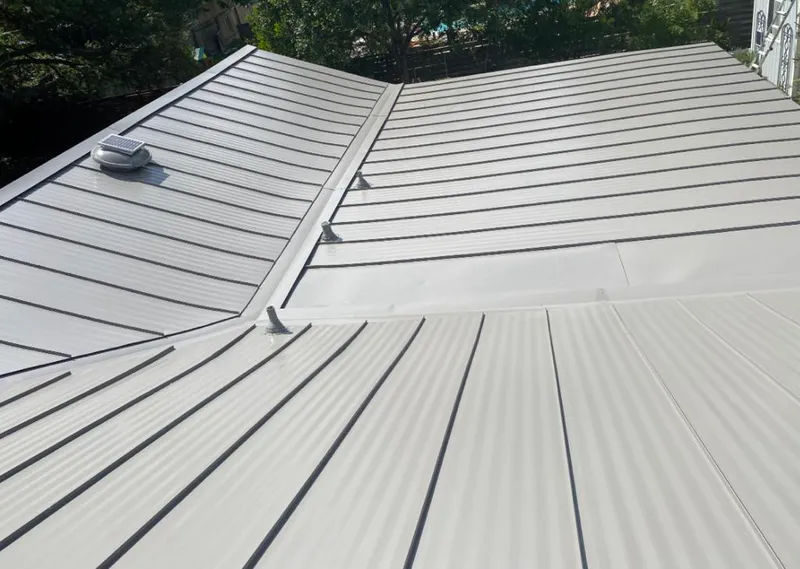 Solar attic fan installed on a metal roof for Roof Ventilation in Grandville